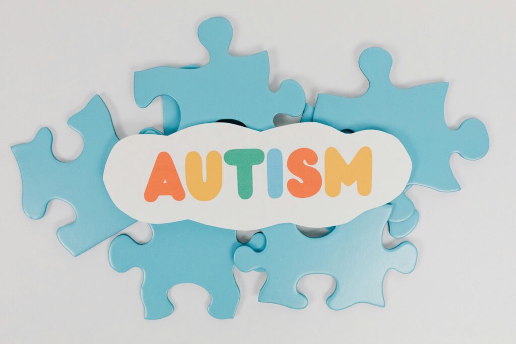 Colorful puzzle pieces with 'AUTISM' text symbolizing autism awareness.